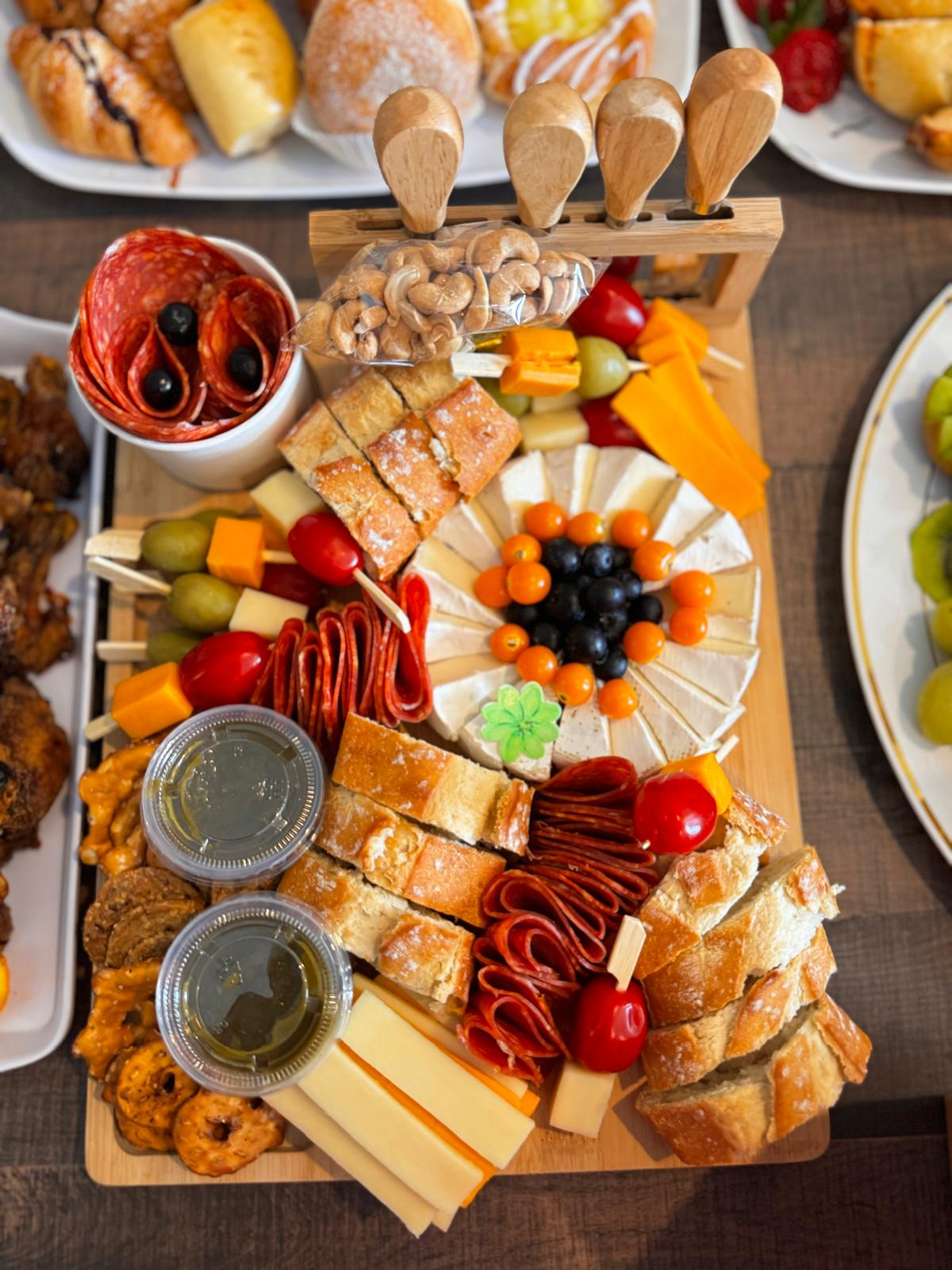 Overhead grazing board with charcuterie, cheese, bread and fruit at a White Oats event