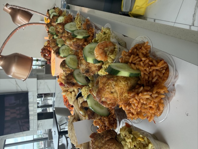 Individual jollof and fried rice portions with chicken in star containers