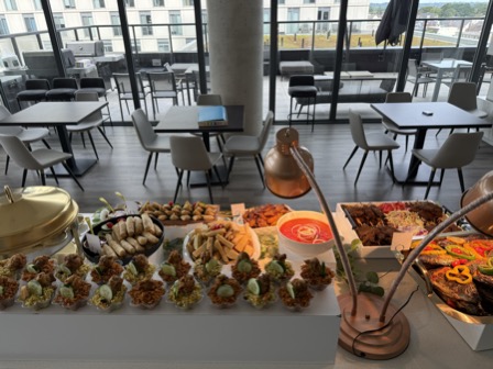 Full buffet spread across a high-rise venue with floor-to-ceiling windows