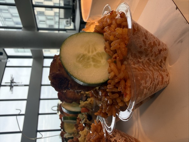 Jollof rice cup with cucumber and chicken