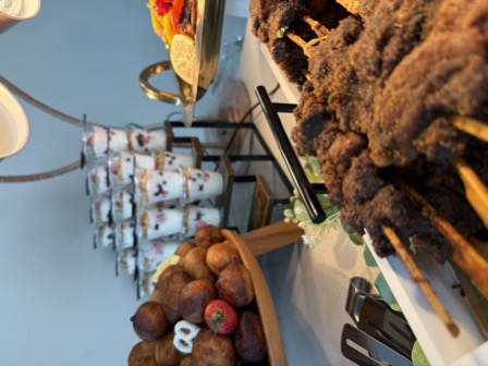Suya skewers, yogurt parfaits and fruit on a catering table