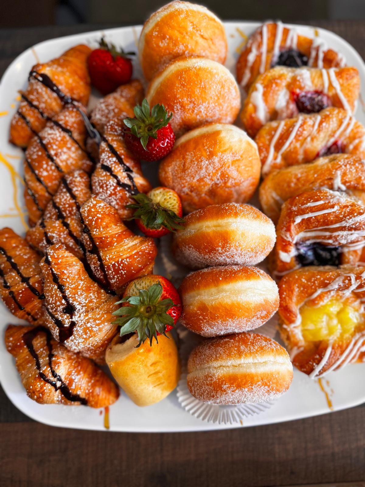 Pastry platter with croissants, donuts and jam pastries